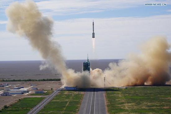 The crewed spacecraft Shenzhou-12, atop a Long March-2F carrier rocket, is launched from the Jiuquan Satellite Launch Center in northwest China's Gobi Desert, June 17, 2021. (Xinhua/Li Gang)