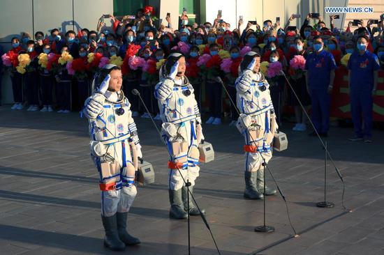 Astronauts Nie Haisheng (C), Liu Boming (R) and Tang Hongbo salute during a see-off ceremony for Chinese astronauts of the Shenzhou-12 manned space mission at the Jiuquan Satellite Launch Center in northwest China, June 17, 2021. (Xinhua/Ju Zhenhua)