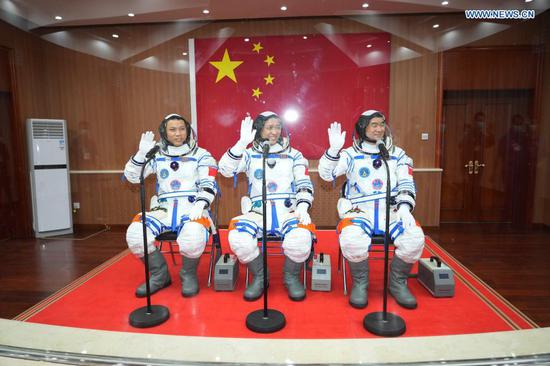 Astronauts Nie Haisheng (C), Liu Boming (R) and Tang Hongbo wave during a see-off ceremony for Chinese astronauts of the Shenzhou-12 manned space mission at the Jiuquan Satellite Launch Center in northwest China, June 17, 2021. (Xinhua/Li Gang)