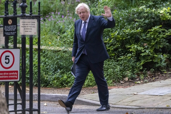 British Prime Minister Boris Johnson walks back to Downing Street after attending a press conference in London, Britain, on July 12, 2021. (Photo by Ray Tang/Xinhua)