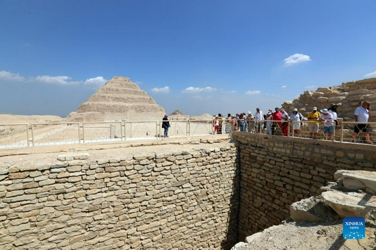 Tourists visit the upper level of the south tomb of King Djoser in Saqqara necropolis, south of Cairo, Egypt, on Sept. 14, 2021. Egypt on Monday opened the south tomb of King Djoser after restoration in Saqqara necropolis near the capital Cairo. The restoration process started in 2006 and involved conservation and restoration work of the lower corridors, strengthening the walls and ceilings, complete the interior inscriptions in the tomb as reassembling the granite sarcophagus. (Xinhua/Sui Xiankai)