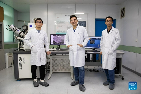 A research team of the Institute of Geology and Geophysics of the Chinese Academy of Sciences poses for a photo in Beijing, capital of China, Oct. 18, 2021. Chinese researchers have studied the lunar samples brought back by the Chang'e-5 mission and dated the youngest rock on the Moon at around 2 billion years in age, extending the "life" of lunar volcanism 800-900 million years longer than previously known. The study, conducted mainly by a research team at the Institute of Geology and Geophysics (IGG), Chinese Academy of Sciences (CAS), was presented in three Nature papers and published online Tuesday. (Xinhua/Jin Liwang)