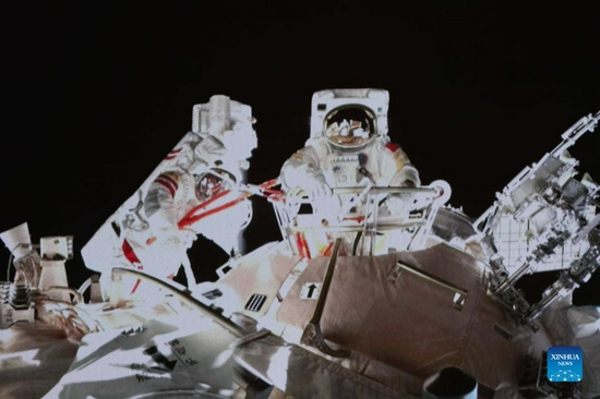 Screen image taken at Beijing Aerospace Control Center on Nov. 8, 2021 shows Chinese taikonaut Wang Yaping (R) completing extravehicular activities (EVAs). Taikonauts Zhai Zhigang and Wang Yaping have completed their extravehicular activities (EVAs) and returned to the space station core module Tianhe, the China Manned Space Agency (CMSA) said on early hours of Monday. The pair returned to the core module at 1:16 a.m. (Beijing Time) after 6.5 hours of extravehicular activities. (Photo by Guo Zhongzheng/Xinhua)