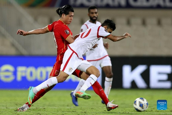 Zhang Yuning (L) of China competes during a Group B match between China and Oman of 2022 FIFA World Cup Asian qualifiers in Sharjah, the United Arab Emirates, on Nov. 11, 2021. (Xinhua)