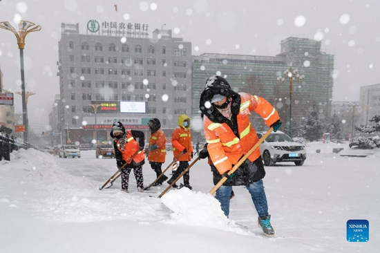 Sanitation workers clear snow from a street in Hegang City, northeast China's Heilongjiang Province, Nov. 22, 2021. Heavy snowfall hit many parts of Heilongjiang recently. Staff members of various sectors are braving frigid gusts and snowflakes to ensure normal availability of essential public services. (Xinhua/Xie Jianfei) 