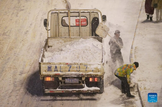 Sanitation workers clear snow from a street in Harbin City, northeast China's Heilongjiang Province, Nov. 22, 2021. Heavy snowfall hit many parts of Heilongjiang recently. Staff members of various sectors are braving frigid gusts and snowflakes to ensure normal availability of essential public services. (Xinhua/Wang Jianwei) 