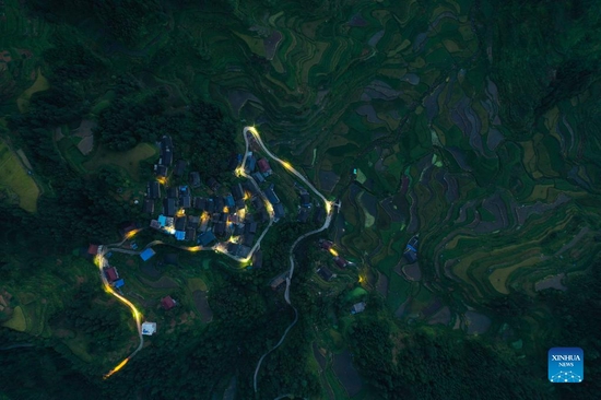 Aerial photo taken on Aug. 31, 2021 shows the night view of Baixiu Village in Gandong Township of Rongshui Miao Autonomous County, south China's Guangxi Zhuang Autonomous Region. More and more solar powered street lamps have been erected in areas tucked away in the mountains in Guangxi, illuminating the night sky for people living there. (Xinhua/Huang Xiaobang) 