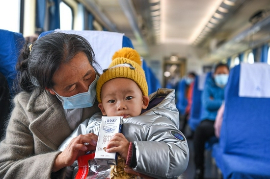 Passengers are seen on the 5647 train running between Zhaotong in southwest China's Yunnan Province and Guiyang in southwest China's Guizhou Province, Nov. 30, 2021. (Xinhua/Yang Wenbin)