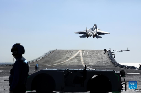 Undated file photo shows a carrier-based J-15 fighter jet taking off during open-sea combat training. The Chinese navy's Liaoning aircraft-carrier formation returned on Dec. 30, 2021 to a military port in Qingdao, east China's Shandong Province, concluding 20-plus days of open-sea combat training. The exercise, which began on Dec. 9, took the formation into various waters, from the Yellow Sea to the East China Sea and the West Pacific, and has improved the formation's combat capability, according to an official statement. (Photo by Hu Shanmin/Xinhua)