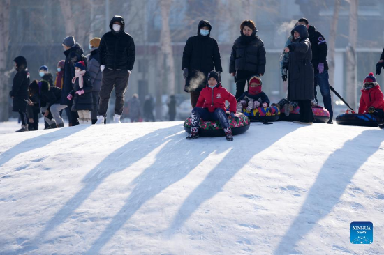 People slide on the ice at a park in Harbin, northeast China's Heilongjiang Province, Jan. 3, 2022. (Xinhua/Wang Jianwei)