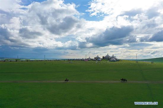 Tourists ride horses at a scenic spot in Hulunbuir, north China's Inner Mongolia Autonomous Region, Aug. 4, 2020. Local authorities in Hulunbuir have taken various measures, such as a more flexible working schedule and issuing tourist coupons, to boost local tourism market. (Xinhua/Xu Qin)