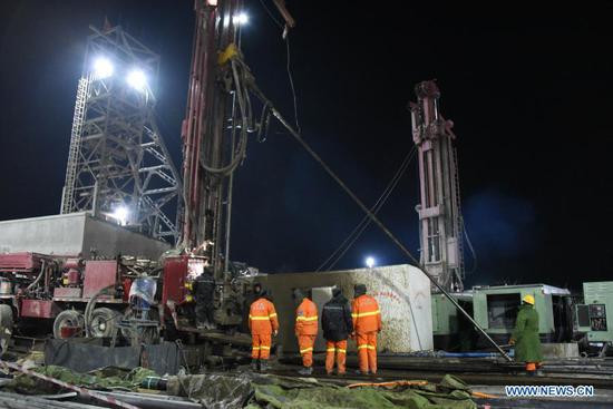 Rescuers drill a new channel at the explosion site of a gold mine in Qixia City, east China's Shandong Province, Jan. 18, 2021. A new channel has been drilled to rescue the workers trapped by a gold mine blast in east China's Shandong Province, authorities said early Monday. The channel, drilled through at around 5 a.m., reaches a section 698 meters from the mine entrance. It came after another channel was drilled Sunday at a section 648 meters from the entrance. Rescuers knocked on the drilling pipe, but have not yet received responses, according to the rescue headquarters. The blast took place at 2 p.m. on Jan. 10 at the gold mine in Qixia under Yantai City. It happened about 240 meters away from the entrance. Twenty-two workers were working more than 600 meters away from there. On late Sunday, a paper slip retrieved from underneath the mine through the previously drilled channel said that 12 workers were still alive while the other 10 were in unclear situations. (Xinhua/Wang Kai)