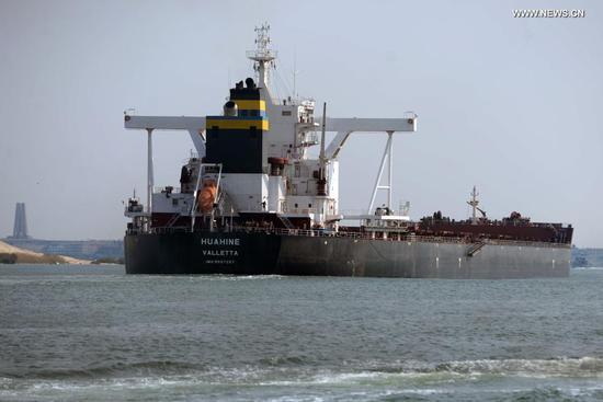 Photo taken on March 30, 2021 shows a ship sailing on the Suez Canal, Egypt. At least 113 container ships have passed through the Suez Canal that was blocked by a massive cargo container, chairman of the Suez Canal Authority (SCA) Osama Rabie said on Tuesday. (Xinhua/Ahmed Gomaa)