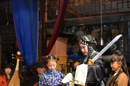 Yunnan Opera master Wang Meizhu (second right) gives lessons to two minor opera performers in Kunming, southwest China's Yunnan Province on Nov. 13, 2021. (Xinhua/Yan Yong)