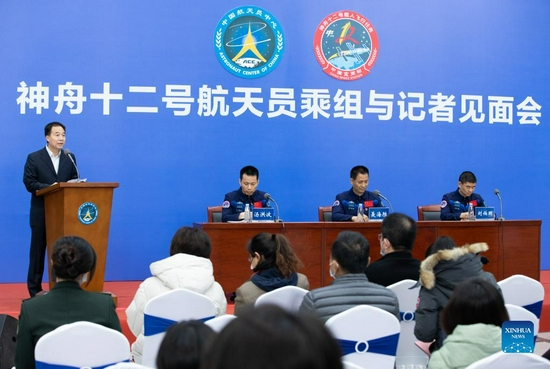 Photo taken on Dec. 7, 2021 shows a press conference held by the China Astronaut Research and Training Center in Beijing, capital of China. Tang Hongbo, Nie Haisheng and Liu Boming, the three astronauts of the Shenzhou-12 spaceflight mission, on Tuesday met with the public and the press here for the first time after their return to Earth. (Xinhua/Jin Liwang)