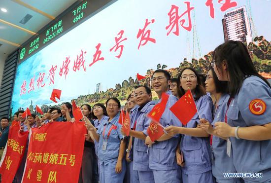  Technicians celebrate the successful launch of the Chang'e-5 spacecraft at the Wenchang Spacecraft Launch Site in south China's Hainan Province, Nov. 24, 2020. China on Tuesday launched a spacecraft to collect and return samples from the moon, the country's first attempt to retrieve samples from an extraterrestrial body. (Xinhua/Jin Liwang)