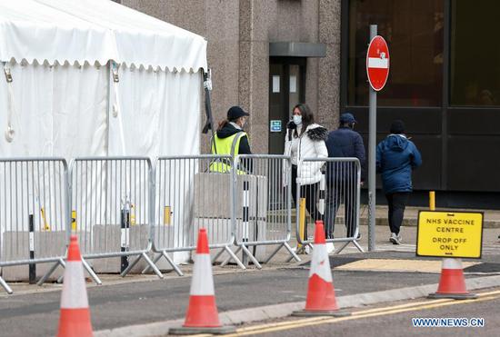 People talk outside an NHS COVID-19 vaccination center in London, Britain, on March 4, 2021. Future vaccines that have been tweaked to deal with new coronavirus variants will be fast-tracked for authorization, Britain's medicines and health care regulator announced Thursday. (Xinhua/Han Yan)