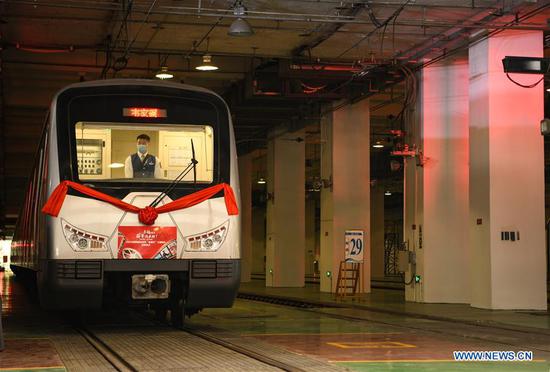 A poverty-alleviation-themed train pulls out of the parking lot in Chengdu, southwest China's Sichuan Province, Oct. 17, 2020. China marked the seventh National Poverty Relief Day on Saturday. A poverty-alleviation-themed train, with photos and videos displaying poverty alleviation achievements in Sichuan, made its first running on the Line 1 of Chengdu Metro on Saturday. The train will run till the end of this year. (Xinhua/Wang Xi)