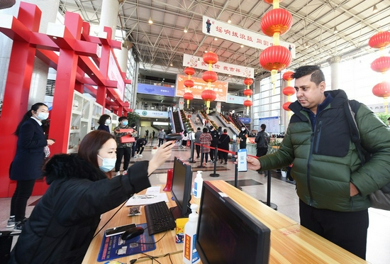 A foreign merchant shows his QR code at the Yiwu International Trade Market in Yiwu City, east China's Zhejiang Province, Feb. 20, 2021. (Photo by Gong Xianming/Xinhua)