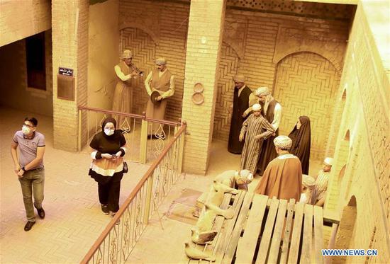 People wearing masks visit the al-Baghdadi Museum in Baghdad, Iraq, Oct. 21, 2020. The traditional al-Baghdadi Museum was reopened to visitors recently, about six months after its closure amid the coronavirus pandemic in Iraq. Located in an old building near the Tigris River, the museum is one of Baghdad's important cultural heritage and tourist landmarks, offering a nostalgic journey into the past daily life of the Iraqi capital through scenes featuring life-size wax models. (Xinhua)