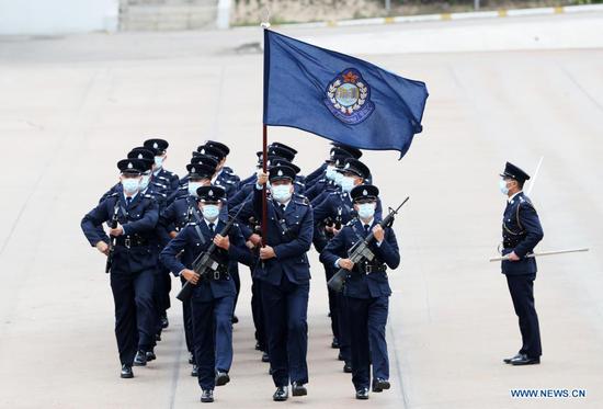 Police officers perform the Chinese-style goose-stepping at the Hong Kong Police College, south China's Hong Kong, April 15, 2021. (Xinhua/Li Gang)