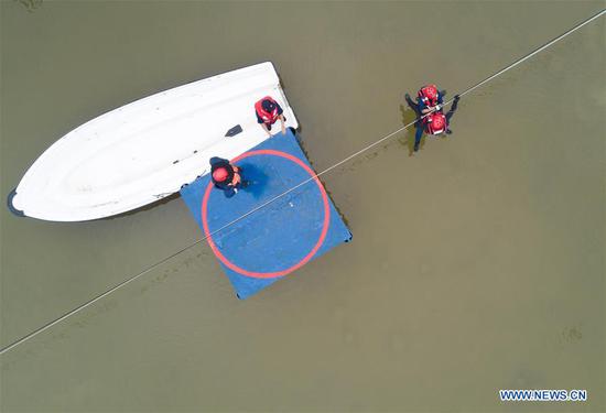 Aerial photo taken on Oct. 22, 2020 shows rescue brigade members competing during a forest fire-fighting competition in Fuzhou, southeast China's Fujian Province. A special rescue skills competition kicked off in Fuzhou on Thursday, with more than 100 firefighters from special rescue brigades participating in the event. (Xinhua/Song Weiwei)