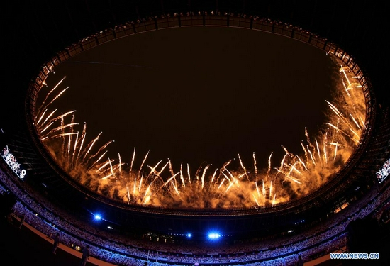 Fireworks explode over the Olympic Stadium during the opening ceremony of Tokyo 2020 Olympic Games in Tokyo, Japan, July 23, 2021. (Xinhua/Cao Can)