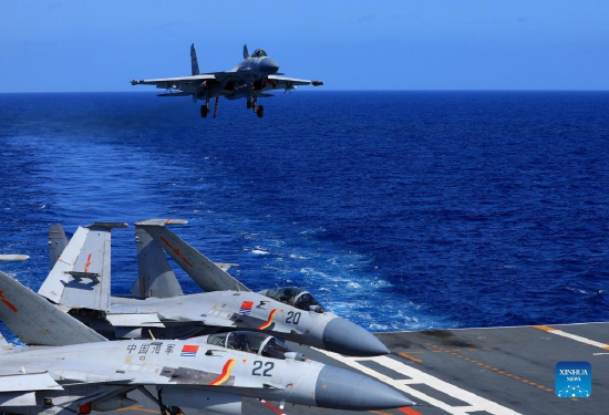 Undated file photo shows a carrier-based J-15 fighter jet preparing to land during open-sea combat training. The Chinese navy's Liaoning aircraft-carrier formation returned on Dec. 30, 2021 to a military port in Qingdao, east China's Shandong Province, concluding 20-plus days of open-sea combat training. The exercise, which began on Dec. 9, took the formation into various waters, from the Yellow Sea to the East China Sea and the West Pacific, and has improved the formation's combat capability, according to an official statement. (Photo by Hu Shanmin/Xinhua)
