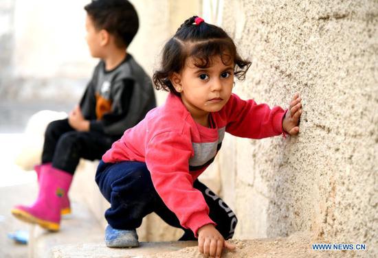 Children play near their house in Damascus, Syria on Nov. 18, 2020. The globe will mark this year's World Children's Day on Friday. (Photo by Ammar Safarjalani/Xinhua)