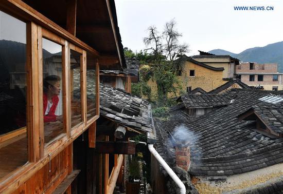 Photo taken on Oct. 21, 2020 shows a view of the home inns in Longtan Village of Pingnan County in Ningde City, southeast China's Fujian Province. Longtan Village had been a provincial-level poverty-stricken village due to lack of arable land. Villagers went out for work one after another with many old buildings left in disrepair. In 2017, the county government launched a project to boost ancient villages through cultural and creative industries. The old houses, once forgotten, have been connected to public utilities, reinforced and decorated inside, with the ancient appearance of the village remained. Moreover, the renaissance here has attracted many people and college graduates outside the village to work here. Nowadays, more and more people come to visit Longtan since the village has become popular on the Internet. (Xinhua/Wei Peiquan)