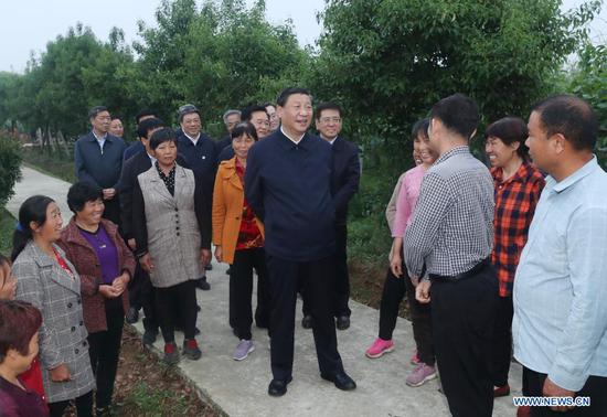 Chinese President Xi Jinping, also general secretary of the Communist Party of China Central Committee and chairman of the Central Military Commission, learns about the resettlement of people relocated because of the South-to-North Water Diversion Project, and measures to develop specialty industries and boost the incomes of resettled residents in Zouzhuang Village, Xichuan County, Nanyang, central China's Henan Province, May 13, 2021. (Xinhua/Wang Ye)