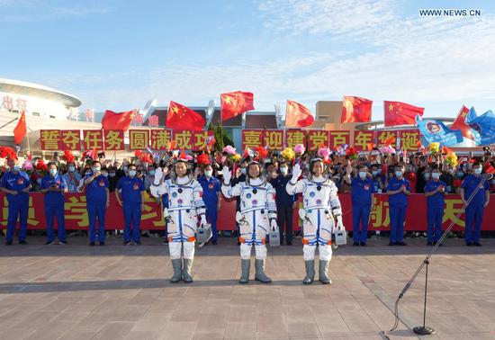 Astronauts Nie Haisheng (R), Liu Boming (C) and Tang Hongbo wave during a see-off ceremony for Chinese astronauts of the Shenzhou-12 manned space mission at the Jiuquan Satellite Launch Center in northwest China, June 17, 2021. (Xinhua/Li Gang)