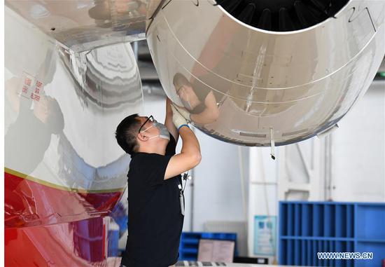 A member of staff works at Bombardier Tianjin Aviation Services Co., Ltd. in Tianjin Pilot Free Trade Zone (FTZ), north China's Tianjin, Sept. 17, 2020. With a number of high-end aviation maintenance enterprises gathering in the FTZ in Tianjin, the area has become an advanced aviation maintenance and testing base in the Asia-Pacific region. (Photo by Zhao Zishuo/Xinhua)