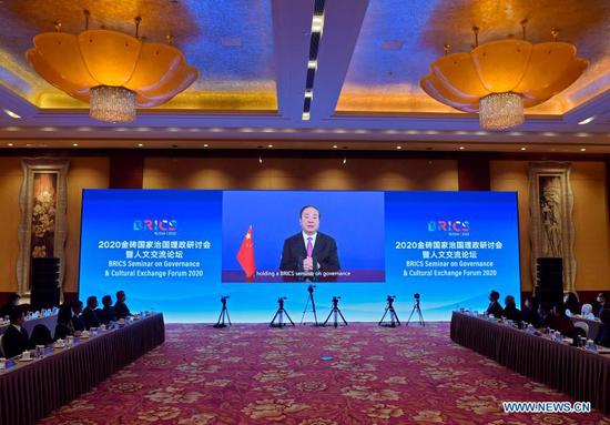 Huang Kunming, a member of the Political Bureau of the Communist Party of China (CPC) Central Committee and head of the Publicity Department of the CPC Central Committee, delivers a keynote speech at the opening ceremony of the 2020 BRICS governance seminar and cultural exchange forum via video link in Beijing, capital of China, Dec. 3, 2020. (Xinhua/Yue Yuewei)