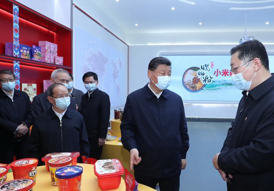 Chinese President Xi Jinping, also general secretary of the Communist Party of China Central Committee and chairman of the Central Military Commission, visits a food-processing zone for local specialty Luosifen rice noodles in the city of Liuzhou, south China's Guangxi Zhuang Autonomous Region, April 26, 2021. (Xinhua/Ju Peng)