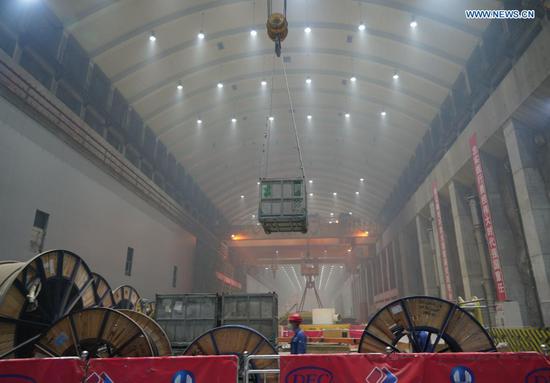 Workers are busy at the construction site of the Baihetan hydropower station in southwest China, April 27, 2021. Construction of the Baihetan hydropower station in southwest China is proceeding smoothly. With a total of 16 homegrown million-kilowatt generating units, Baihetan hydropower station, located on the Jinsha River, the upper section of the Yangtze, straddling Yunnan and Sichuan provinces, is the second-largest in China after the Three Gorges Dam project in the central province of Hubei in terms of installed capacity. (Photo by Liang Zhiqiang/Xinhua)