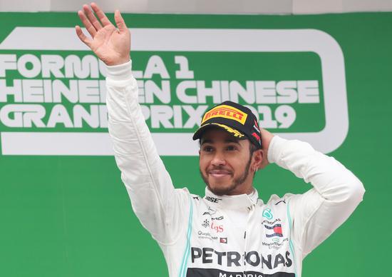 Mercedes driver Lewis Hamilton celebrates on the podium after winning the 2019 Chinese Grand Prix at the Shanghai International Circuit. (Xinhua/Ding Ting)