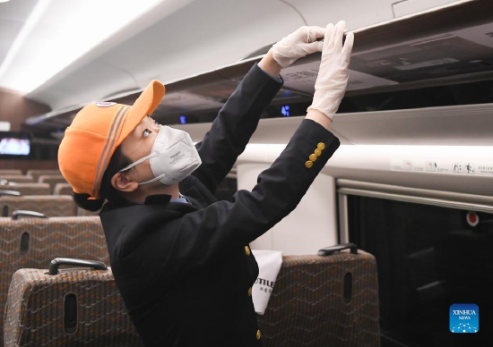 A staff member carries out a hygienic check on a train in Wuhan, central China's Hubei Province, Jan. 16, 2022. The number of railway passenger trips during China's upcoming Spring Festival travel rush is expected to jump 28.5 percent from the holiday season last year, industry data shows. During the 40-day travel season, also known as chunyun, many Chinese people will travel to meet their families for the Chinese Lunar New Year, or Spring Festival, which will fall on Feb. 1, 2022. (Xinhua/Cheng Min)