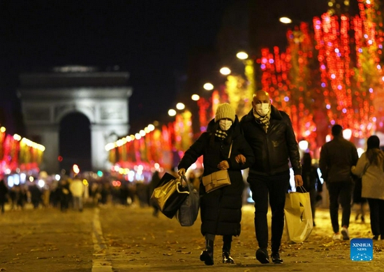 People walk on the Champs-Elysees Avenue amid Christmas illuminations in Paris, France, Nov. 21, 2021. The annual Christmas season lighting ceremony was held here on Sunday. (Xinhua/Gao Jing) 