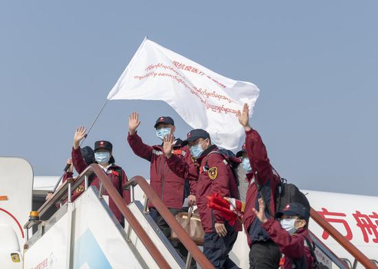 Members of a medical team assisting the Myanmar government's efforts in fight against COVID-19 board the plane before departure at the Kunming Changshui International Airport in Kunming, southwest China's Yunnan Province, April 8, 2020. (Photo by Chen Xinbo/Xinhua)