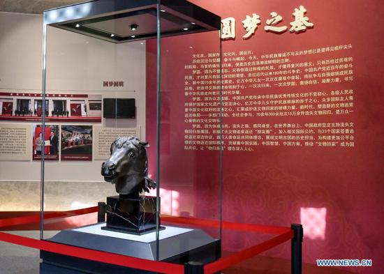 A bronze horse head sculpture looted from Yuanmingyuan is on display at Wenshu Pavilion of Zhengjue Temple in Yuanmingyuan, Beijing, capital of China, Dec. 1, 2020. A bronze horse head sculpture, a treasure of China's Old Summer Palace that went missing after an Anglo-French allied forces' looting 160 years ago, returned to its original palace home Tuesday. It is the first time that a lost important cultural relic from the Old Summer Palace, or 