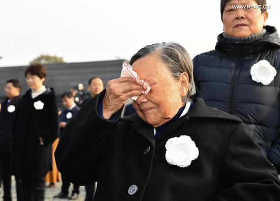 Survivor of the Nanjing Massacre Xia Shuqin (front) attends the national memorial ceremony for the Nanjing Massacre victims at the Memorial Hall of the Victims of the Nanjing Massacre by Japanese Invaders in Nanjing, capital of east China's Jiangsu Province, Dec. 13, 2020. (Xinhua/Li Xiang)