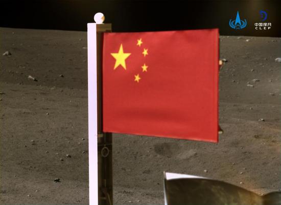 Image released by the China National Space Administration (CNSA) on Dec. 4, 2020 shows China's national flag unfurled from the Chang'e-5 probe on the moon. The image was taken by a panoramic camera installed on the lander-ascender combination of the probe, before the ascender blasted off from the moon with lunar samples late Thursday. (CNSA/Handout via Xinhua)