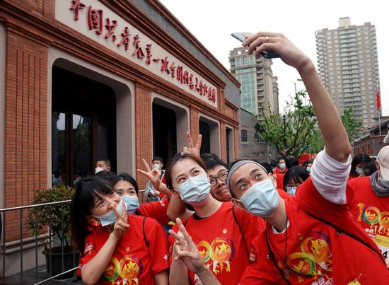 Young people pose for photos at the site of the first National Congress of the Communist Party of China in Shanghai, east China, May 4, 2021. (Xinhua/Liu Ying)