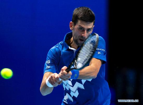 Novak Djokovic of Serbia hits a return during the singles group match against Diego Schwartzman of Argentina at the ATP World Tour Finals 2020 in London, Britain, on Nov. 16, 2020. (Xinhua/Han Yan)