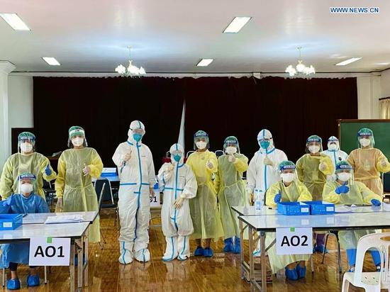 Experts of a Chinese medical team visit a COVID-19 testing site in Vientiane, Laos, May 7, 2021. (Photo by Nong Lichun/Xinhua)