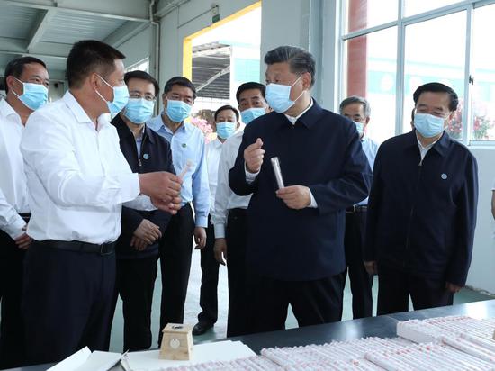 Chinese President Xi Jinping, also general secretary of the Communist Party of China Central Committee and chairman of the Central Military Commission, visits a local company producing mugwort products, inspecting how Nanyang uses the herb to develop its specialty industries, create more jobs and boost local employment, in Nanyang, central China's Henan Province, May 12, 2021. Xi Jinping on Wednesday inspected the city of Nanyang in Henan Province. (Xinhua/Ju Peng)