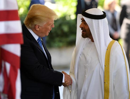 U.S. President Donald Trump (L) welcomes Sheikh Mohamed bin Zayed Al-Nahyan, Abu Dhabi Crown Prince of the United Arab Emirates (UAE), at the White House in Washington, D.C., the United States, on May 15, 2017. (Xinhua/Yin Bogu)