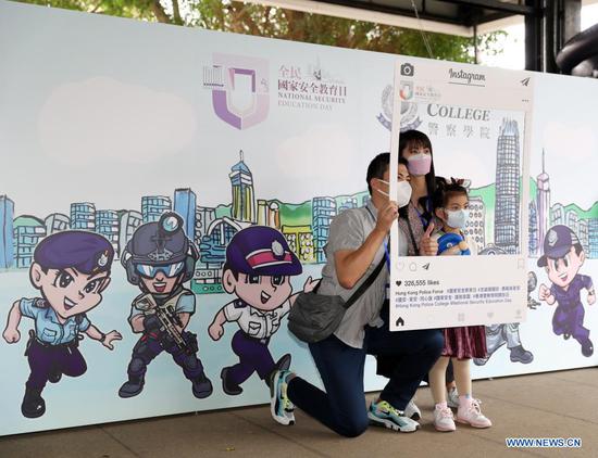 Citizens pose for a photo during an activity themed on National Security Education Day at the Hong Kong Police College in south China's Hong Kong, on April 15, 2021. Hong Kong on Thursday embraced its first National Security Education Day after the law on safeguarding national security in the Hong Kong Special Administrative Region (HKSAR) came into force in mid-2020. Various activities, including lectures, exhibitions, mosaic walls and doors open days of disciplined services, were held to boost the public awareness of safeguarding national security in the global financial hub. (Xinhua/Li Gang)