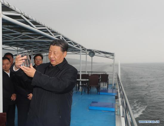 Chinese President Xi Jinping, also general secretary of the Communist Party of China Central Committee and chairman of the Central Military Commission, inspects the Danjiangkou Reservoir and listens to introductions to the construction, management and operation of the middle route of the South-to-North Water Diversion Project, and the ecological conservation of the water source region in Xichuan County, Nanyang, central China's Henan Province, May 13, 2021. (Xinhua/Wang Ye)